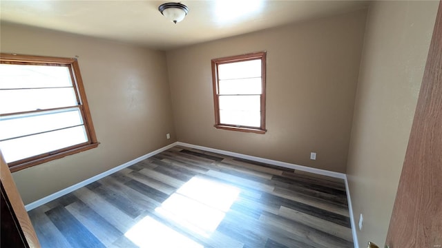 empty room with dark hardwood / wood-style floors