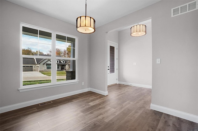 unfurnished dining area with dark hardwood / wood-style floors