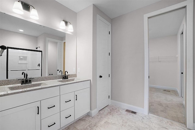 bathroom featuring vanity and a shower with door