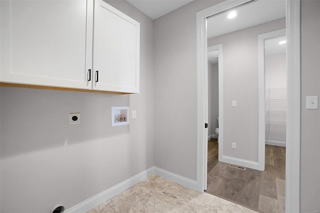 clothes washing area featuring hookup for a washing machine, hookup for an electric dryer, and cabinets