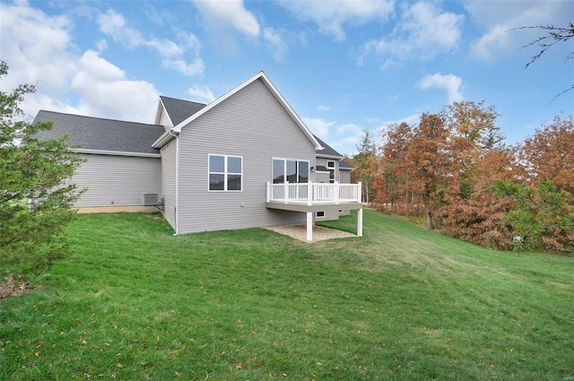 back of house featuring a wooden deck and a yard