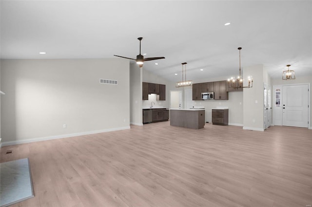 unfurnished living room featuring high vaulted ceiling, sink, ceiling fan with notable chandelier, and light hardwood / wood-style floors