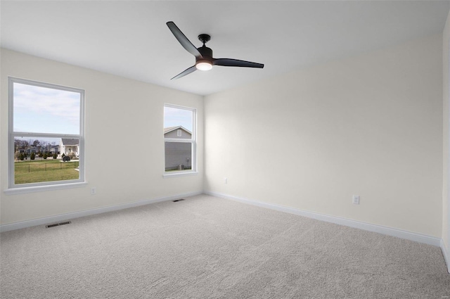 carpeted empty room featuring ceiling fan