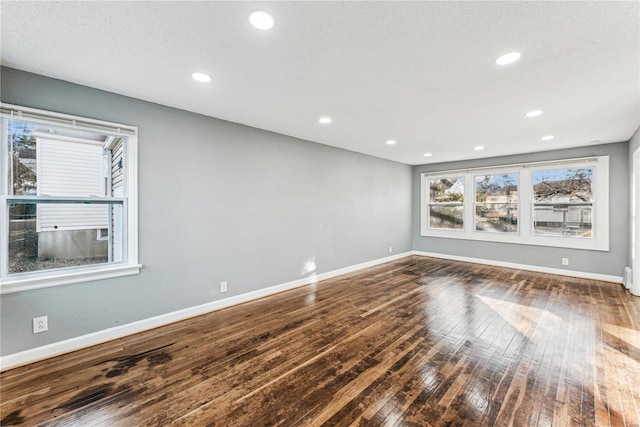 empty room with hardwood / wood-style floors