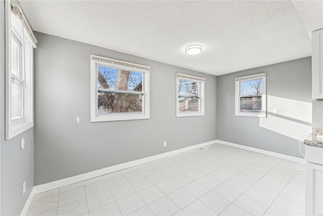 spare room with a textured ceiling