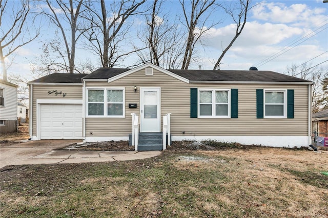 view of front of property with a garage and a front lawn