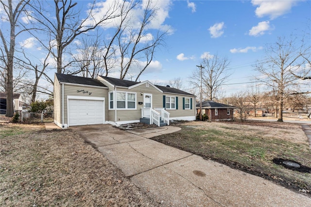 view of front of property featuring a garage and a front lawn