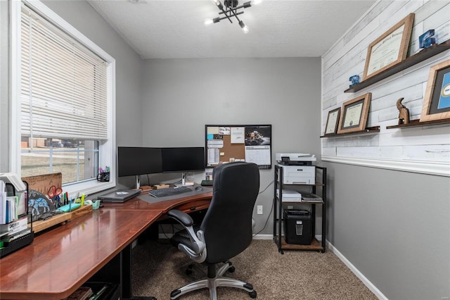 carpeted home office with a textured ceiling