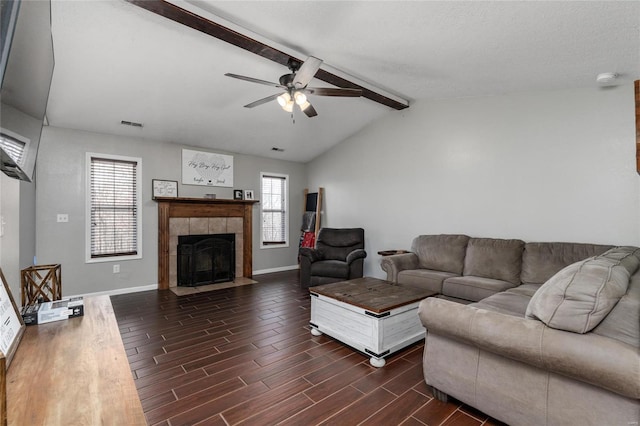 living room featuring lofted ceiling with beams, ceiling fan, and a fireplace