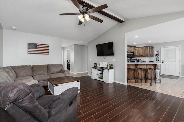 living room featuring vaulted ceiling with beams, hardwood / wood-style floors, and ceiling fan