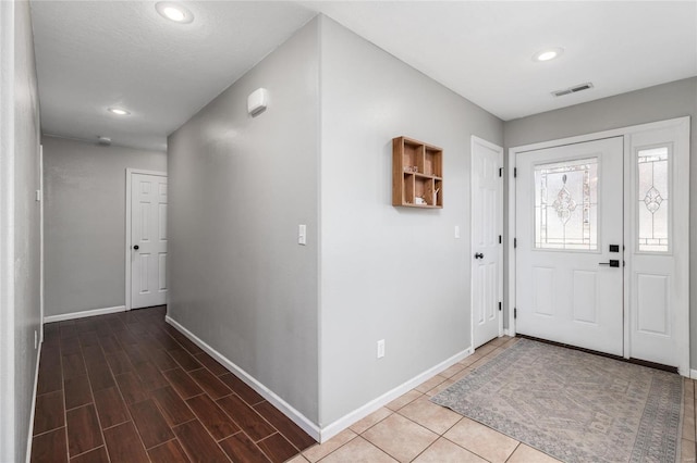 foyer with dark hardwood / wood-style floors