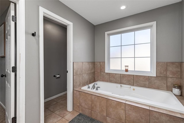 bathroom featuring a relaxing tiled tub and tile patterned floors