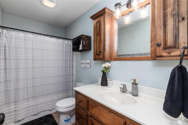 bathroom featuring vanity, walk in shower, and toilet