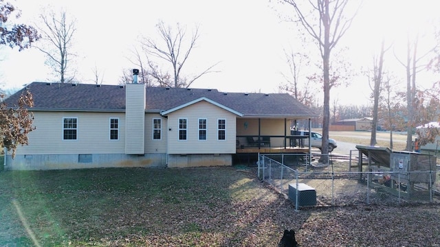 rear view of property with a lawn