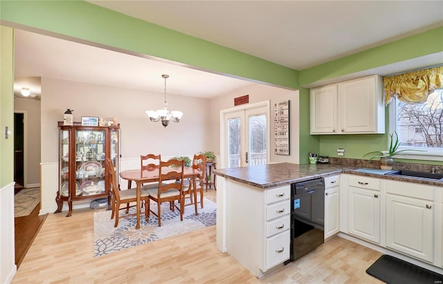 kitchen featuring white cabinetry, dishwasher, hanging light fixtures, kitchen peninsula, and light hardwood / wood-style flooring