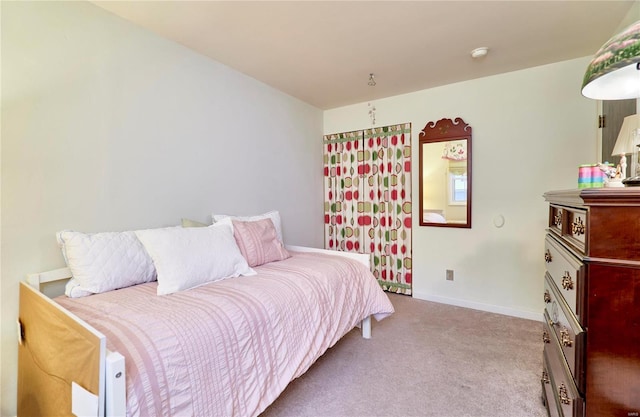 bedroom featuring light colored carpet