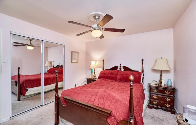 bedroom featuring ceiling fan, a closet, and light carpet