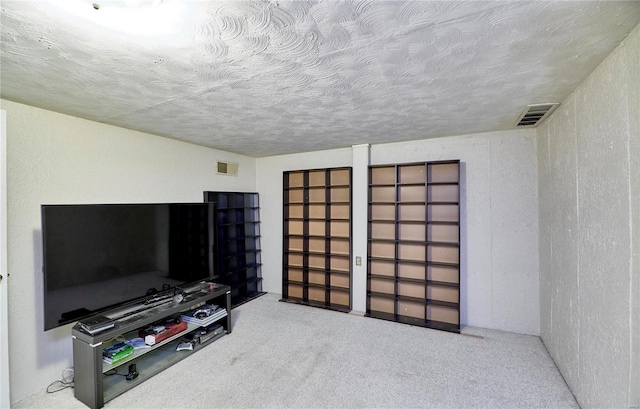 carpeted living room with a textured ceiling