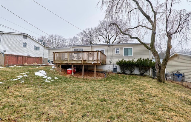 back of house featuring a yard, central AC, and a deck