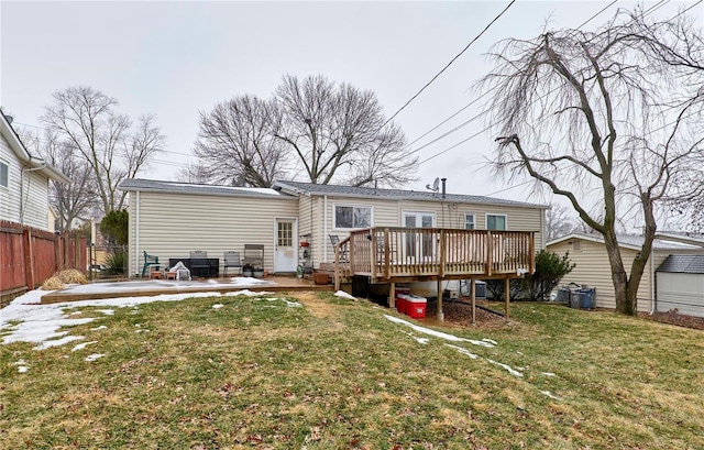 rear view of property with cooling unit, a wooden deck, a lawn, and a patio