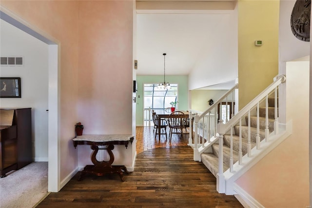 staircase featuring an inviting chandelier and hardwood / wood-style floors