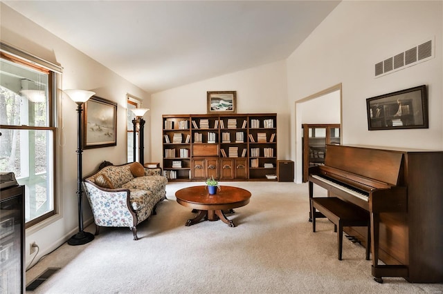 living area with light carpet and vaulted ceiling