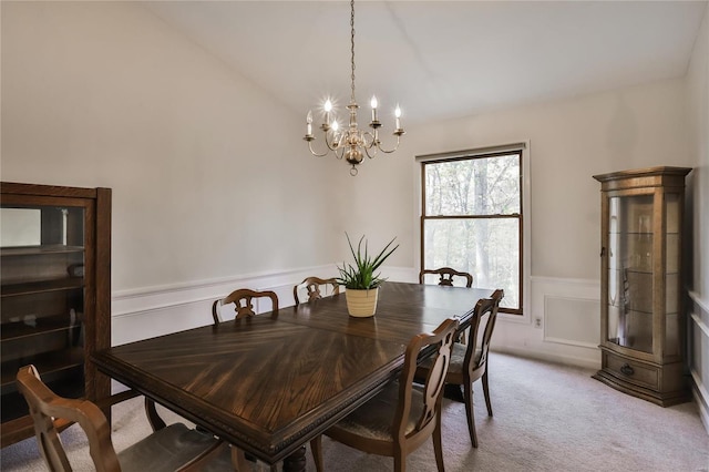 dining room featuring light carpet and a notable chandelier