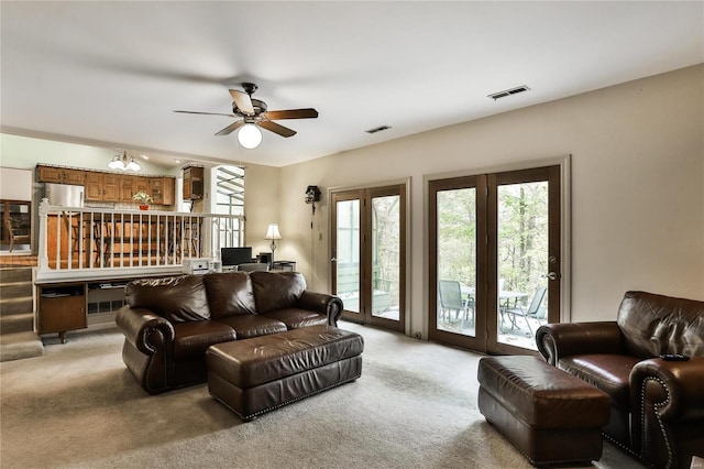 carpeted living room with ceiling fan