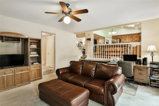 living room featuring light carpet and ceiling fan with notable chandelier