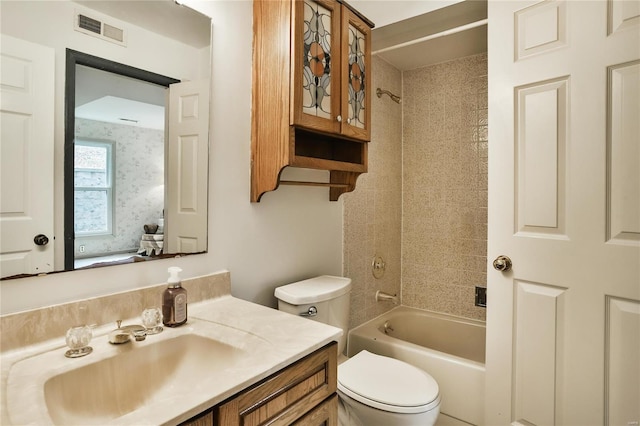 full bathroom featuring vanity, toilet, and tiled shower / bath