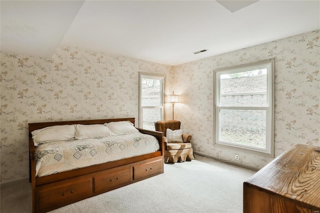 bedroom with carpet and multiple windows