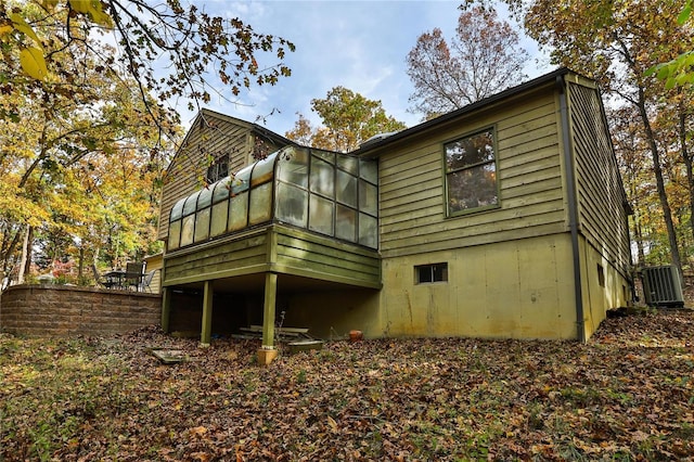 rear view of house featuring a sunroom