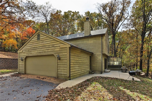 view of side of home with a garage