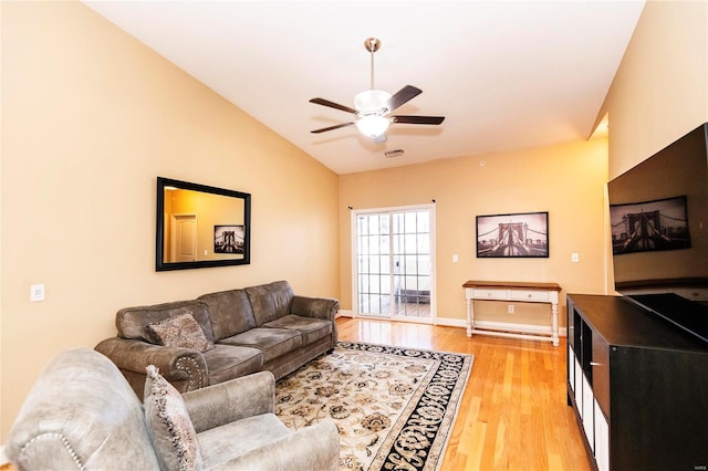 living room featuring lofted ceiling, light hardwood / wood-style flooring, and ceiling fan