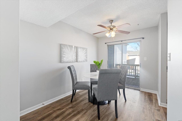 dining area with ceiling fan, wood-type flooring, and a textured ceiling