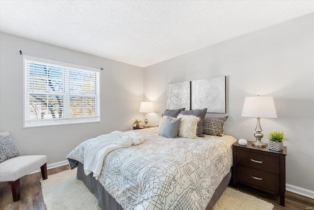 bedroom with hardwood / wood-style floors and a textured ceiling