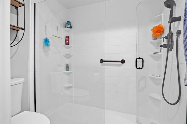 bathroom featuring an enclosed shower and toilet