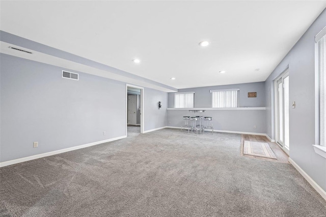 unfurnished living room featuring carpet floors