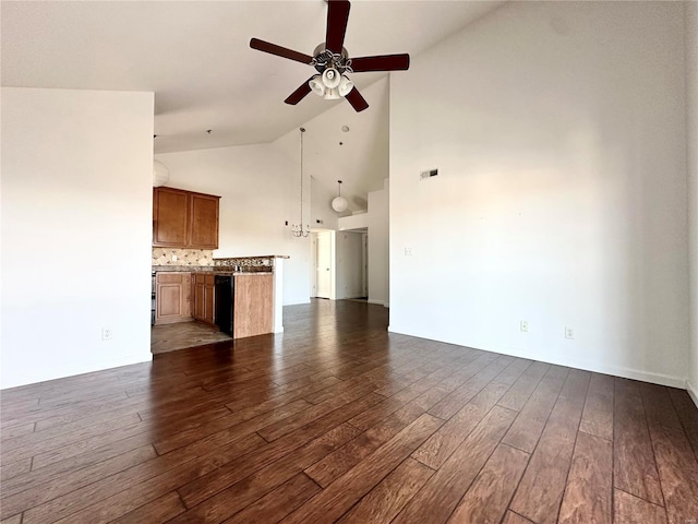 unfurnished living room with ceiling fan, high vaulted ceiling, and dark hardwood / wood-style flooring