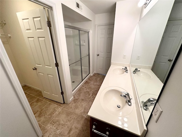 bathroom featuring vanity and an enclosed shower