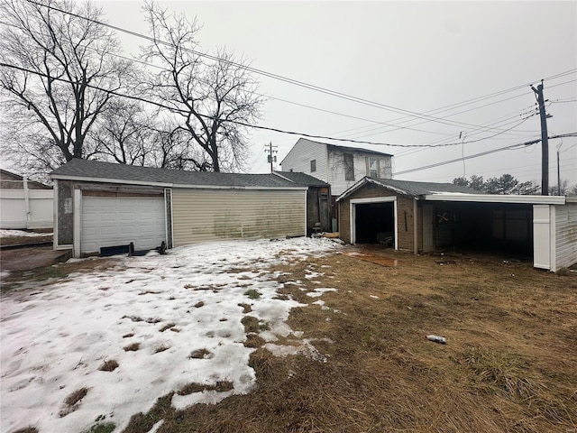 exterior space with an outbuilding, a garage, and a carport