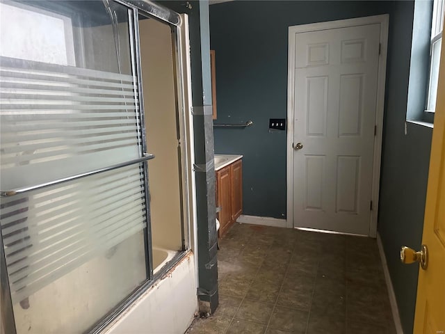 bathroom featuring vanity and bath / shower combo with glass door