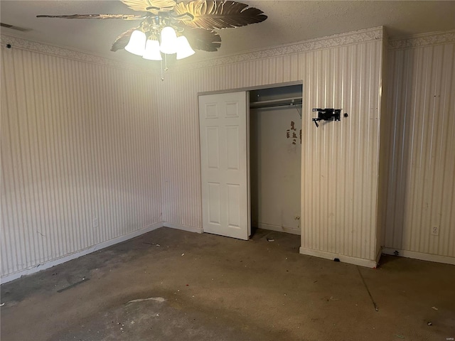 unfurnished bedroom featuring ceiling fan, concrete flooring, and a closet