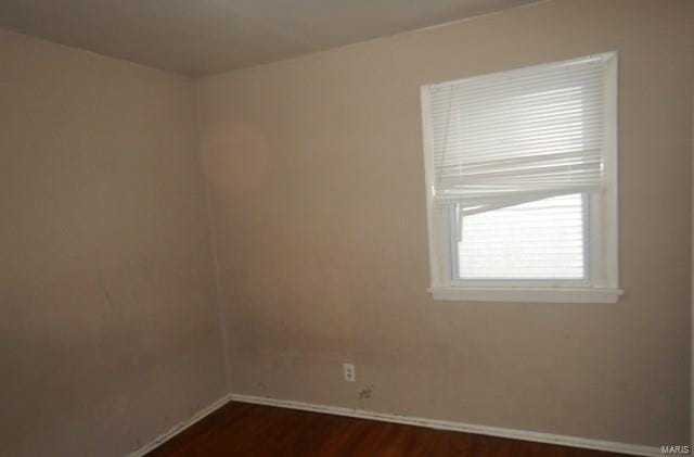 spare room featuring dark hardwood / wood-style flooring