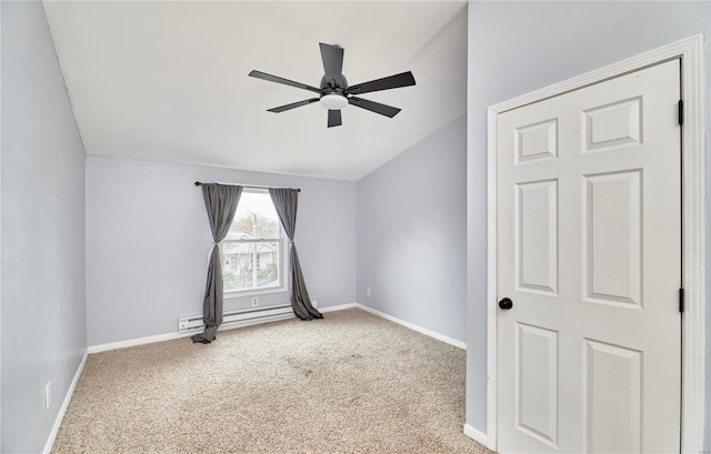 spare room featuring a baseboard heating unit, lofted ceiling, carpet flooring, and ceiling fan