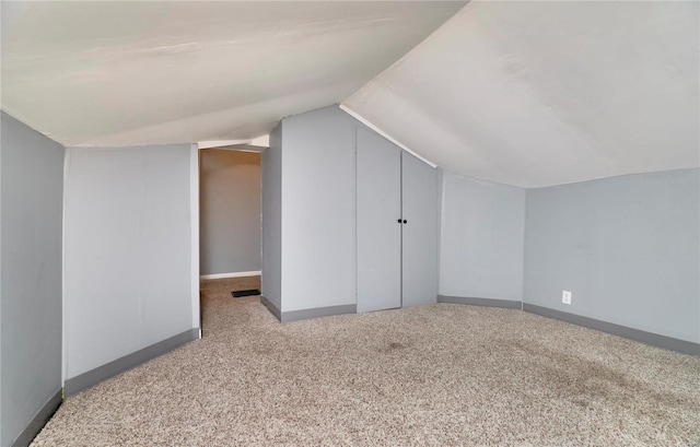 bonus room featuring light colored carpet and lofted ceiling