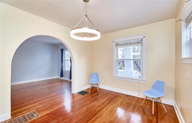 empty room featuring hardwood / wood-style flooring and a healthy amount of sunlight