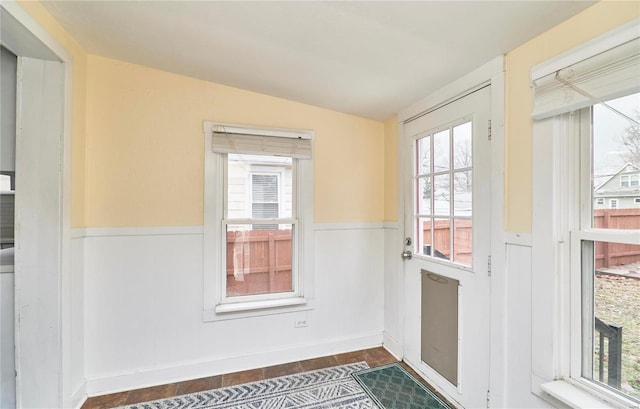 doorway to outside with vaulted ceiling