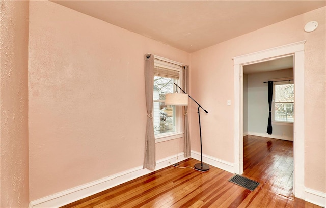 unfurnished room featuring hardwood / wood-style flooring