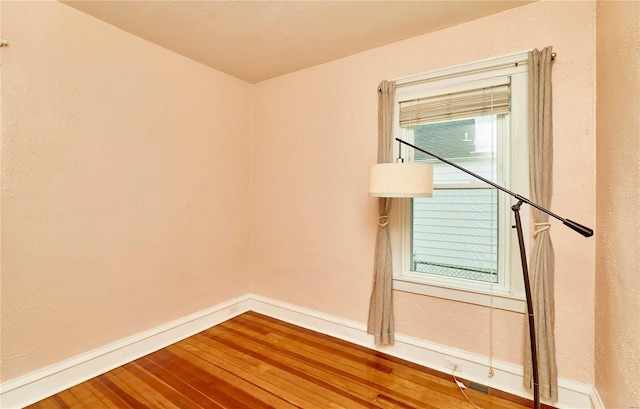 unfurnished room featuring hardwood / wood-style floors